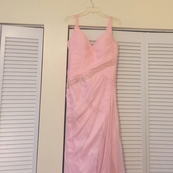 Baby pink wedding dress with a long train.