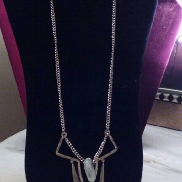 Long gold necklace with white onyx stone