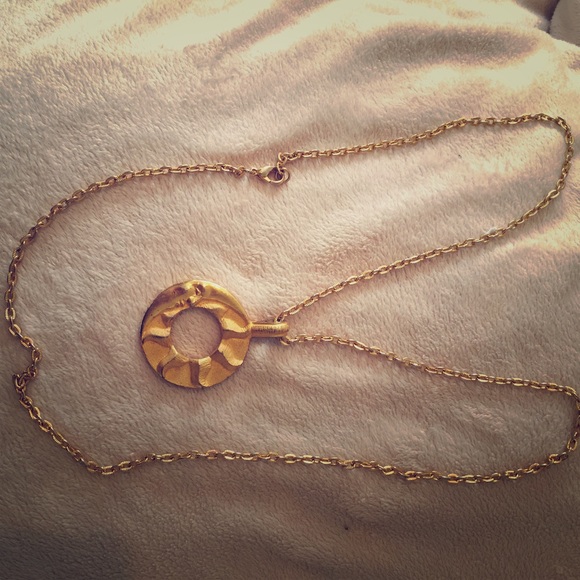 Necklace with a charm that is half moon and sun