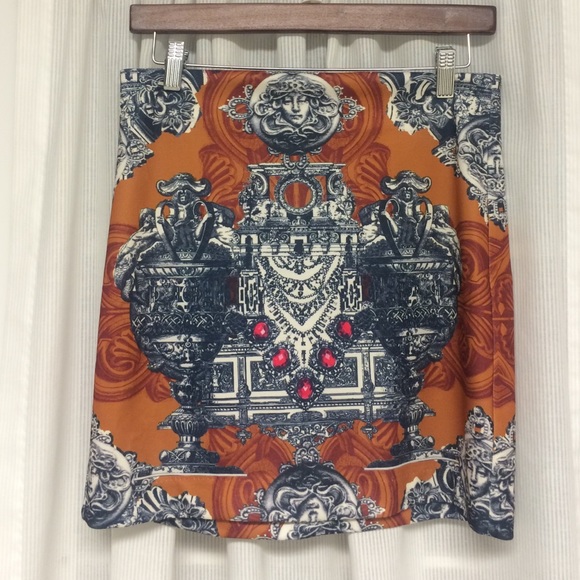 Orange mini skirt w/ printed medusa design