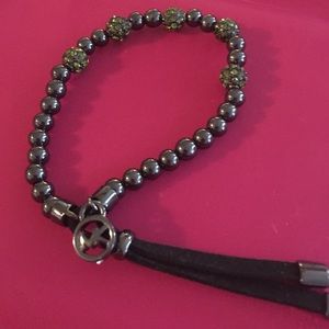 2 Michael kors bracelets gold and dark stone