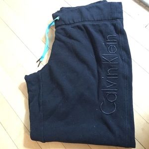 Black Calvin Klein sweat pants.