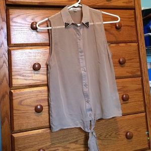 Tan button up shirt.