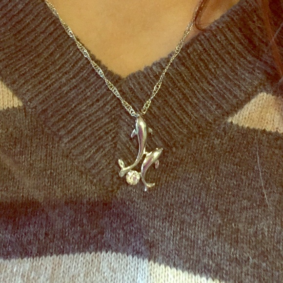 Adorable dolphin pendent with cz stone.