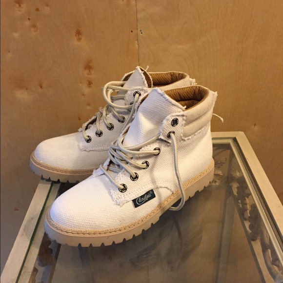 Cream colored boots.