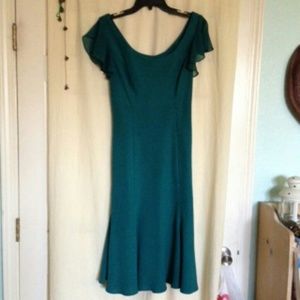 Teal green midi length dress.