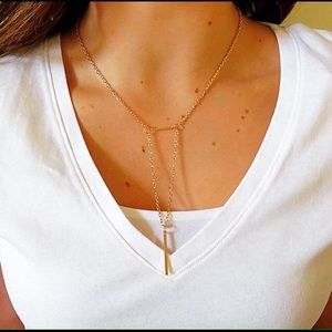 Dainty gold triangle chain.