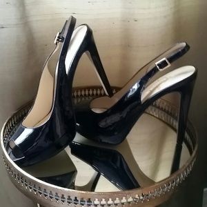 Black patent leather peep toe pumps