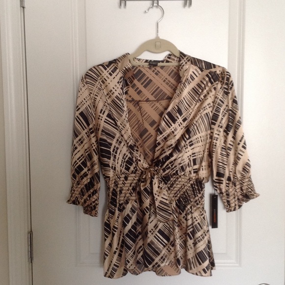 3/4 sleeve peplum top with plunging neckline.