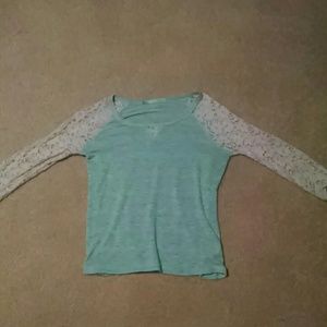A light green half sleeve shirt with lace sleeves