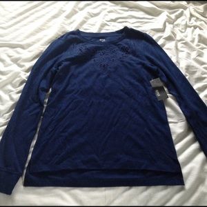 Blue sweater with cut out details around neck