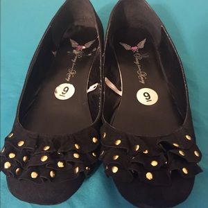 Black ballet flats with gold studs.