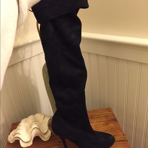 Black over the knee high heel boot.