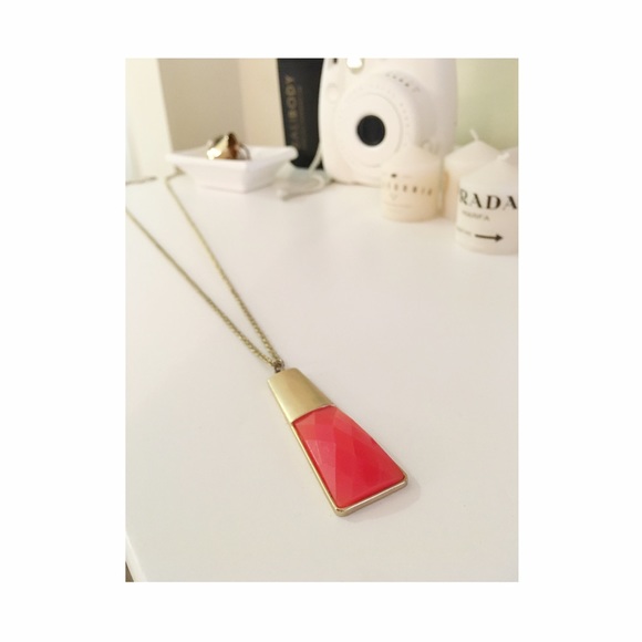 Long gold chain with coral/orange pendant
