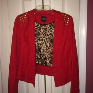 Red XOXO jacket with gold studs on shoulder.