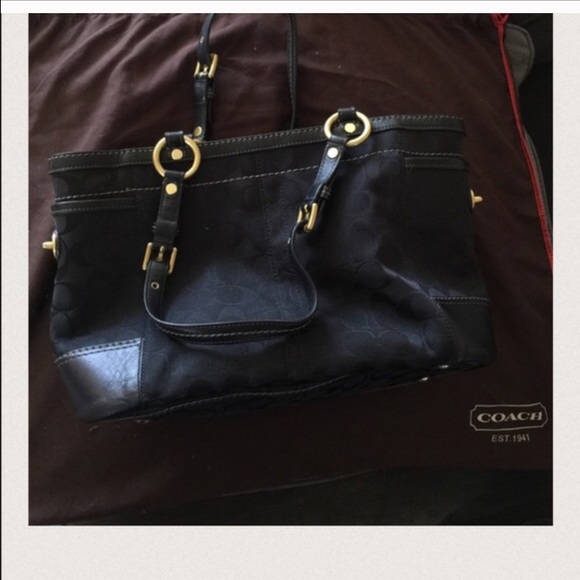 Black coach bag with gold accents.