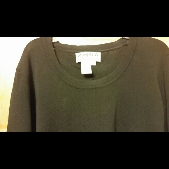 blouse black with cuffs above wrist.