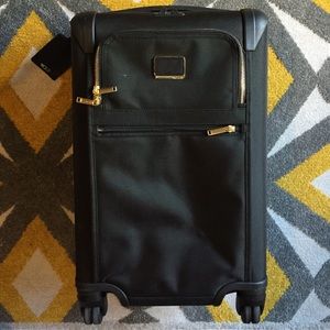 Tumi Carry On rolling suitcase