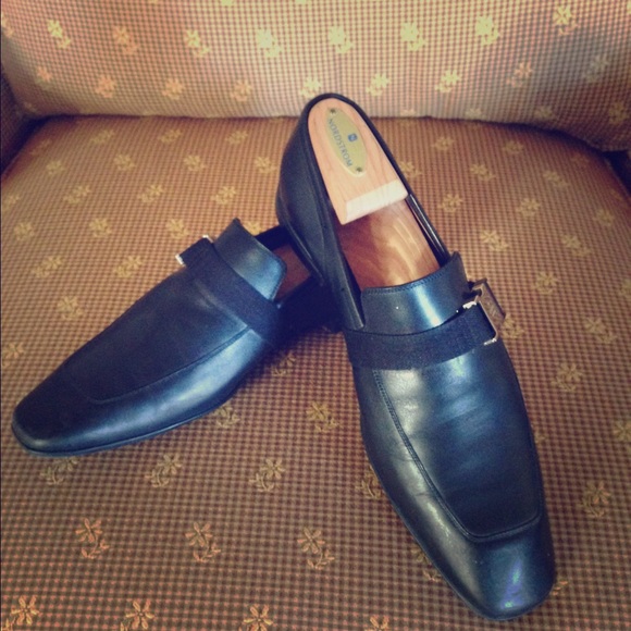 Pair of Gucci shoes with a buckle