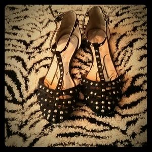 Black studded T-strap flats.