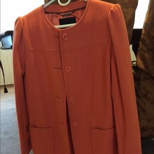 Orange button down coat.