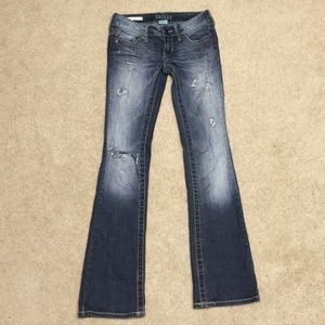 Dark blue holed bootcut jeans from Decree