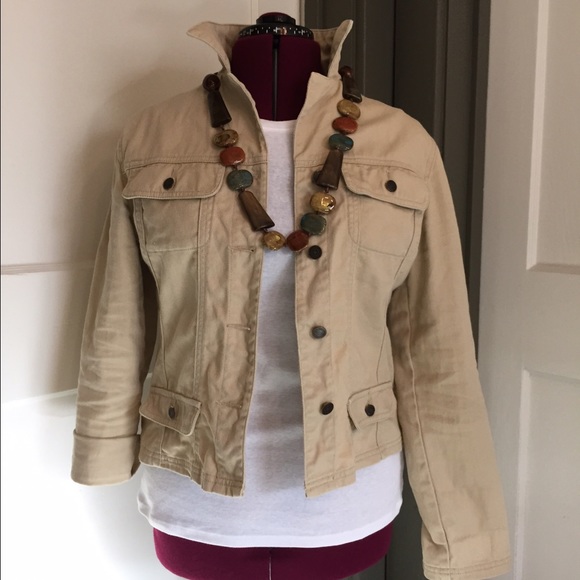 Tan denim jacket with roll up sleeves.