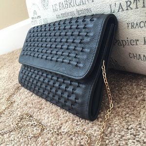 Black woven print clutch purse with gold chain