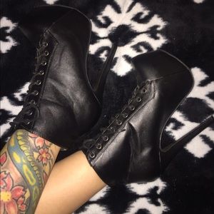 Black lace up leather booties.