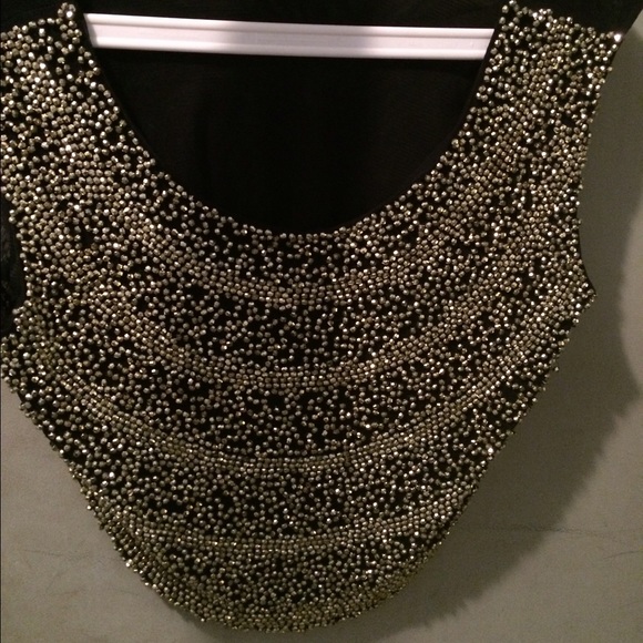 Outgoing gold and black cropped top