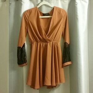 Rust colored mini dress with lace inserts at arm
