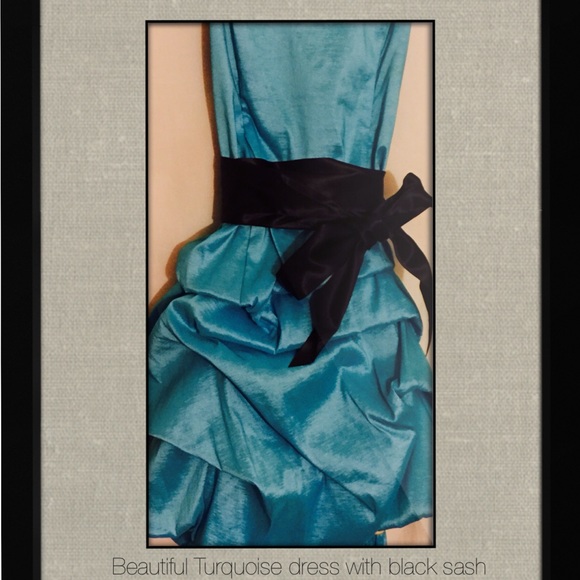 Turquoise party dress with black sash.