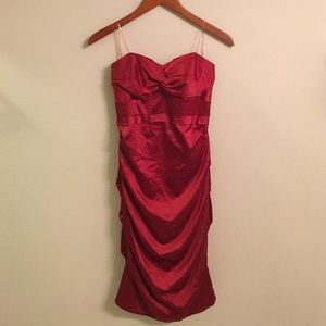 Wine red, strapless, cinched dress.