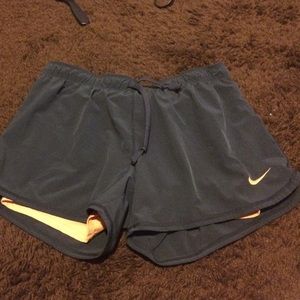 Grey and light orange Nike shorts
