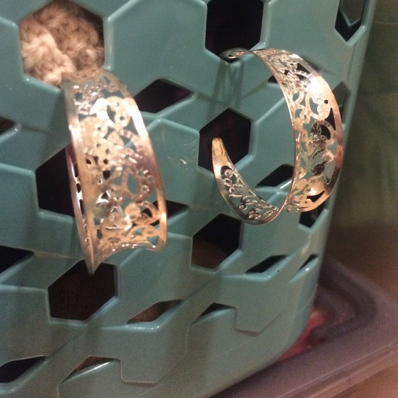 Half hoop silver earrings.