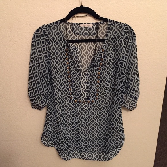 Super cute top with metal embellishments!