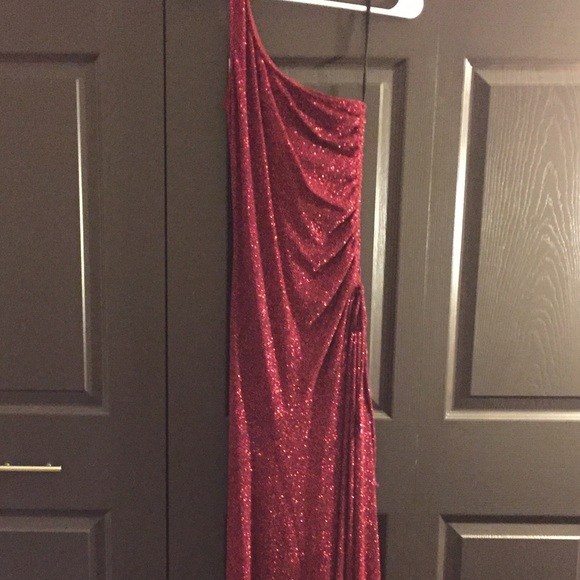 Red sequined dress with leg slit.