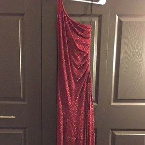 Red sequined dress with leg slit.
