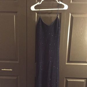 Blue sequined dress with slit in the back.