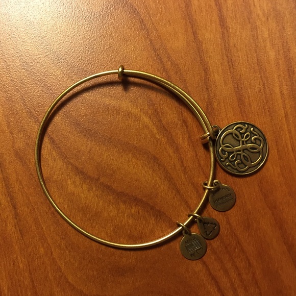 Gold bangle with charms