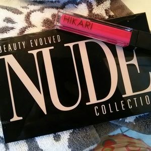 Eye-shadow compact and red lip gloss.