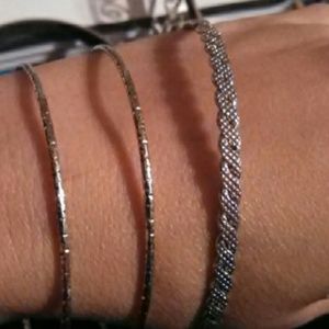 Three silver tone bracelets