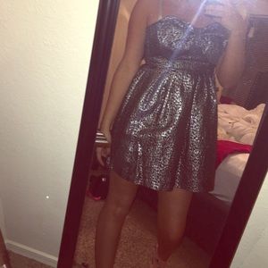 silver and black short dress with bow attached.