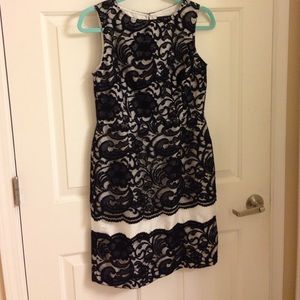 Sleeveless black and white lace holiday dress.