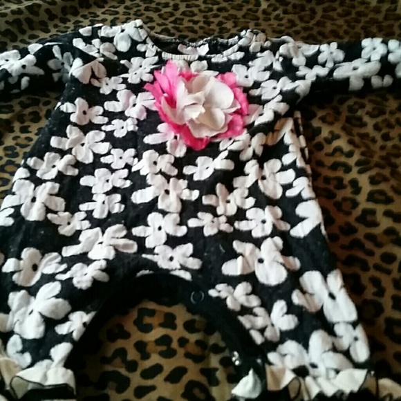Babys romper with a flower and ruffled legs