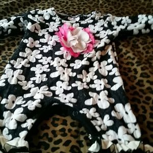 Babys romper with a flower and ruffled legs