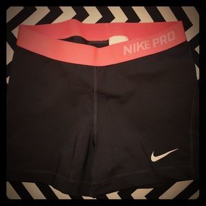 Dark brown and coral Nike Pro shorts