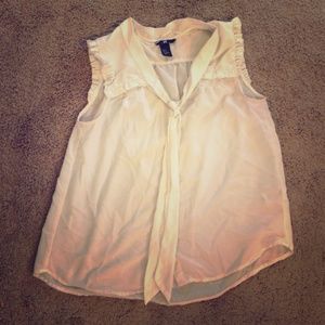 White sleeveless sheer blouse.