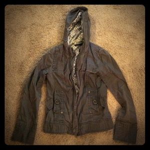 Gray hooded zip up jacket.