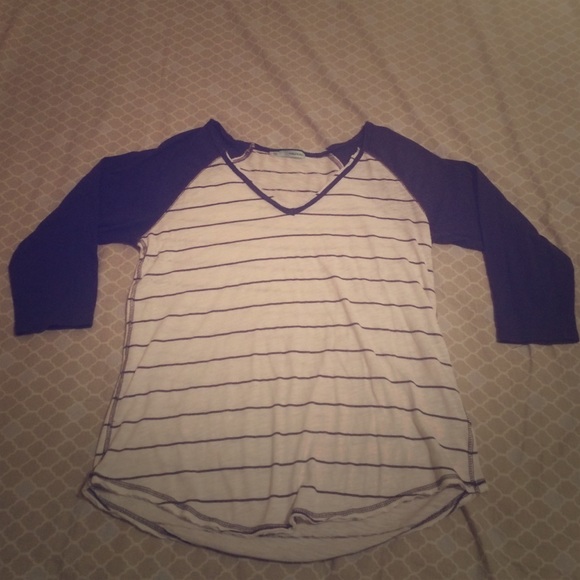 White/blue v neck shirt with frayed neck line.
